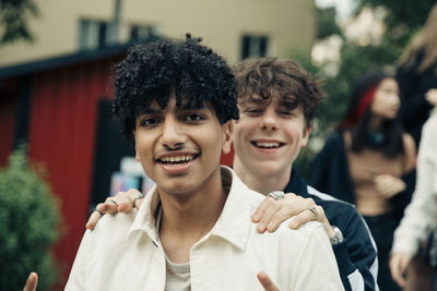 Portrait of smiling male friends in park