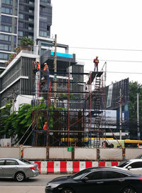 People working at construction site in city