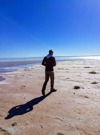 Full length of man on beach against clear sky