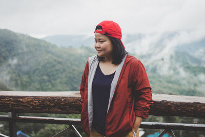 Woman standing against mountains