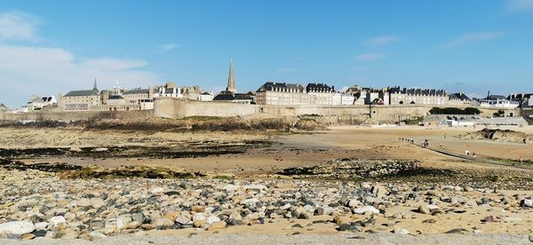 Panoramic view of beach and buildings against sky