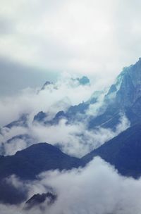 Scenic view of mountains against cloudy sky