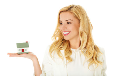 Portrait of a smiling young woman over white background