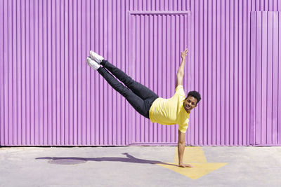 Full length of man skateboarding on wall