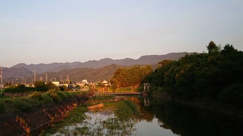 Scenic view of lake and mountains against clear sky