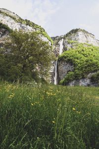 Scenic view of waterfall against sky