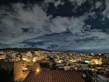 High angle view of illuminated buildings against sky at dusk