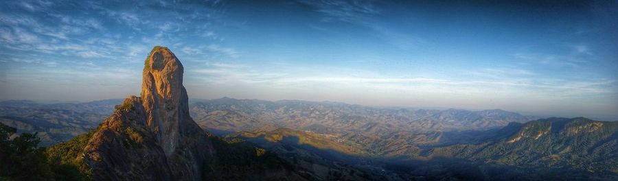 Panoramic view of mountains against blue sky