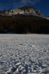 Frozen landscape against sky