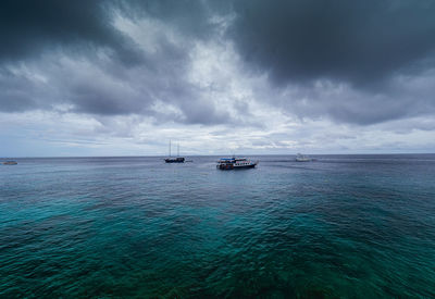 Sailboats on sea against sky