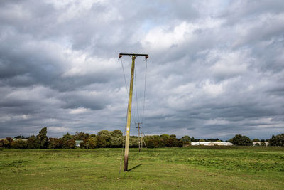 Windmill on field against sky