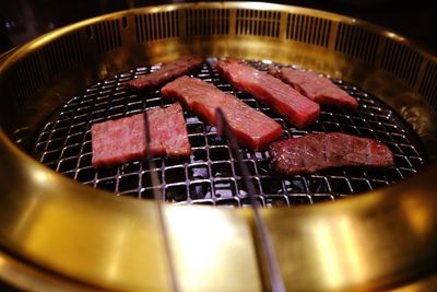 High angle view of meat on barbecue grill