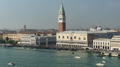 View of church by river against sky