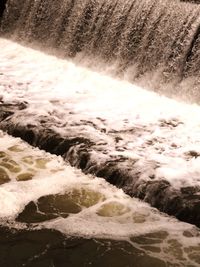 Scenic view of waterfall in sea