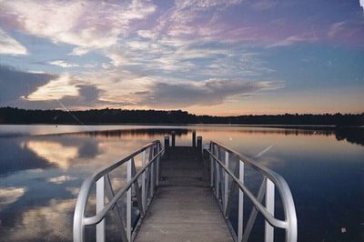 Scenic view of lake against sky at sunset