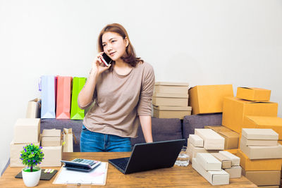 Young woman using phone on table