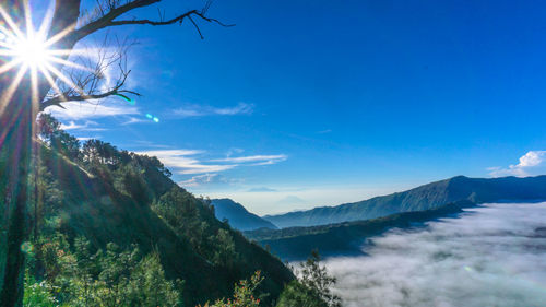 Scenic view of mountains against blue sky