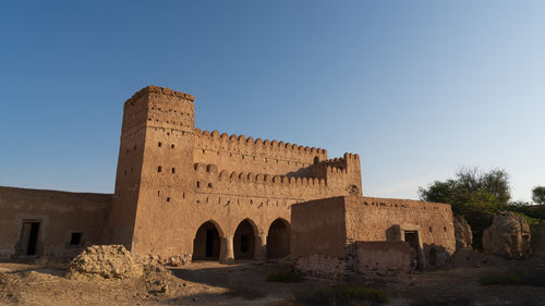 Low angle view of old building against clear sky