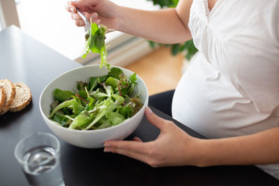 Midsection of woman preparing food