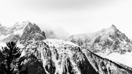 Scenic view of snow covered mountains against sky