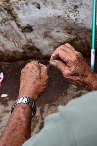 Cropped hands of man preparing fishing bait