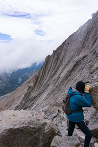 Rear view of man walking on rock