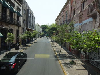 Road amidst buildings in city