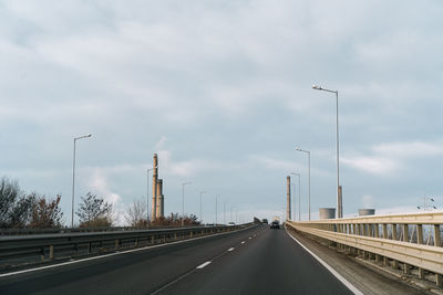 View of highway against tower and sky