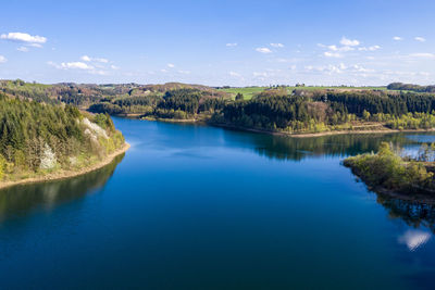 Scenic view of lake against blue sky