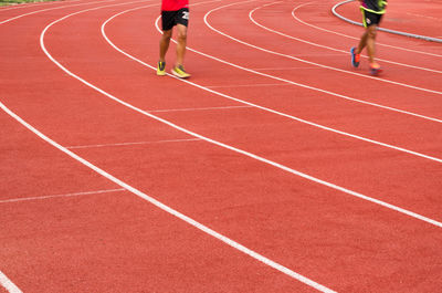 Full length of men running on sports track