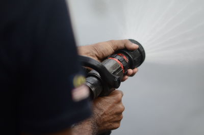 A man hold handline nozzle