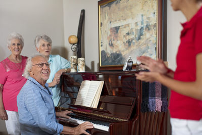 Elderly people making music in retirement home