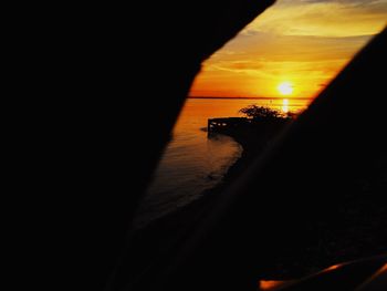 Scenic view of sea against orange sky during sunset