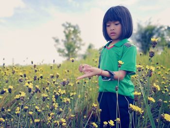 Full length of girl standing on field