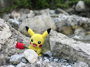 Close-up of yellow toy on rock
