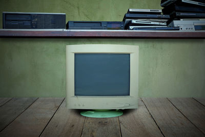 Empty seats on table against wall