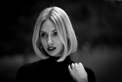 Portrait of young woman standing outdoors