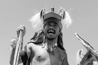 Low angle view of man standing against sky