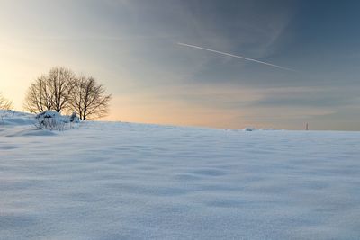 Scenic view of frozen landscape against sky