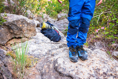 Low section of man standing on rock