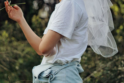 Midsection of woman holding plant