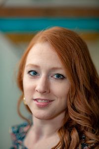 Close-up portrait of redhead smiling young woman 