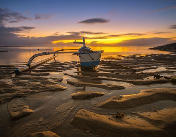 Scenic view of beach against sky during sunset