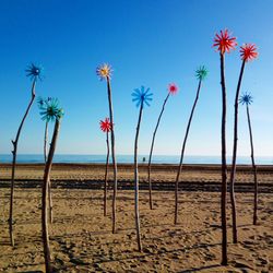 Palm trees on beach against clear blue sky