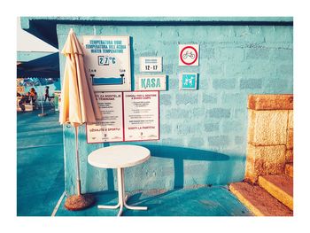 Empty chairs and tables against wall in building