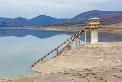 Scenic view of lake against cloudy sky