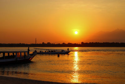 Scenic view of sea against orange sky during sunset