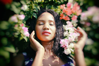 Portrait of woman with red flower