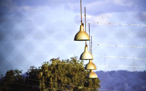 Pendant lights hanging against sky