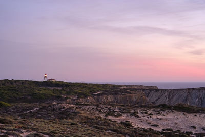 Rock formations on landscape against sky during sunset